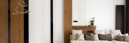 Panorama of elegant living room with decorated wall in wood, white molding and black tiles