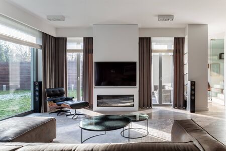 Elegant designed living room with big tv and modern fireplaceの写真素材