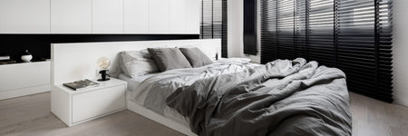 Panorama of stylish bedroom designed in white with big windows with black blinds