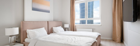 Panorama of comfortable and modern guest bedroom with two beds, tv on the wall and amazing view