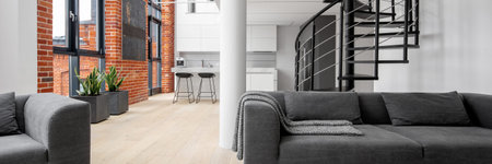 Panorama of modern loft apartment with exposed brick on walls, big windows, black spiral staircase...