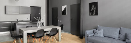 New designed apartment with white and gray walls, wooden floor and gray furnitureの写真素材
