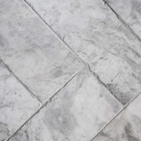 Close-up on modern gray, rectangle shaped floor tiles put in herringbone patternの写真素材
