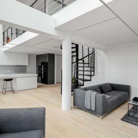 White, modern and spacious two-story apartment with mezzanine floor and stairsの写真素材