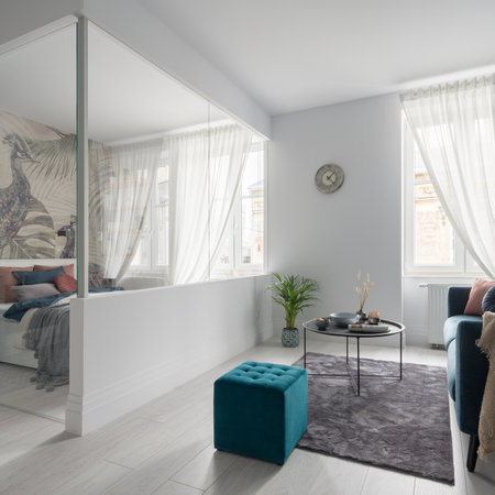Glazed bedroom with stylish wallpaper in elegant and bright, small studio apartmentの写真素材