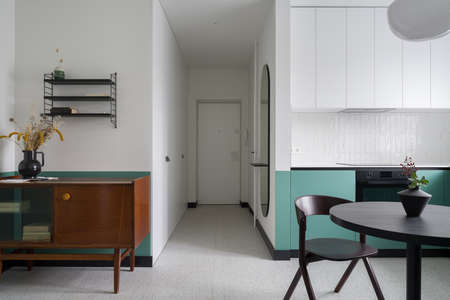 Stylish apartment interior with eclectic design in kitchen open to corridorの写真素材