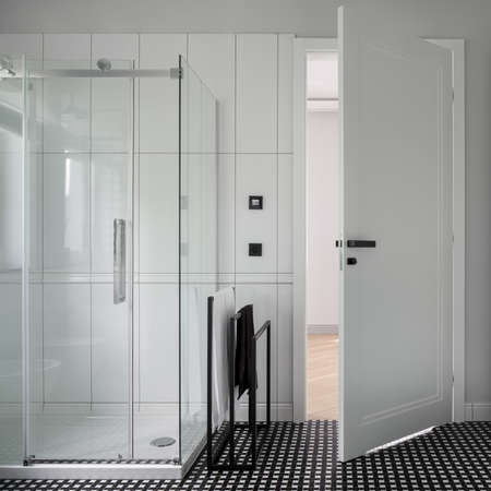 Modern bathroom in black and white with stylish mosaic floor tiles and showerの写真素材