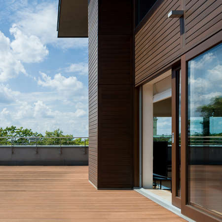 Spacious and nice terrace with wooden floor and walls, exterior viewの写真素材