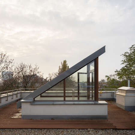Exterior view of small roof terrace with stylish entry, wooden floor and city viewの写真素材