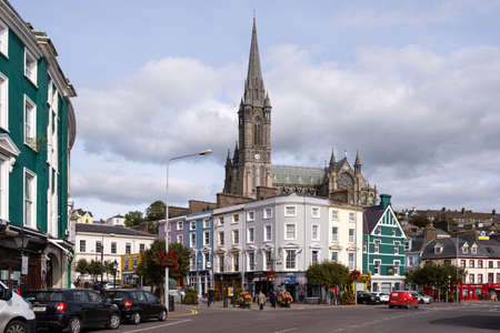 View of Cobh city in Ireland with colorful buildings and St. Colman's Cathedral in the backgroundの写真素材