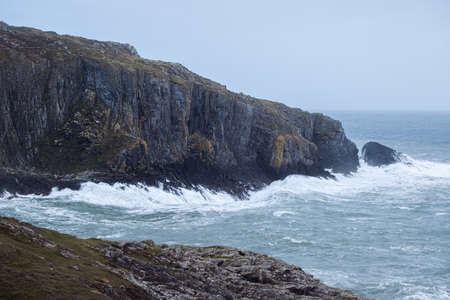 Amazing landscape of nature on rocky cliffs in Ireland with big ocean wavesの写真素材