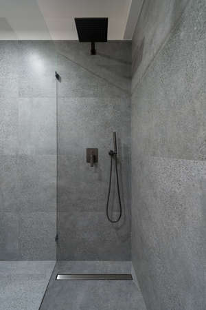 Simple and elegant shower area in granite tiles on floor and wallの写真素材