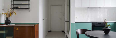 Panorama of stylish apartment interior with eclectic design in kitchen open to corridorの写真素材