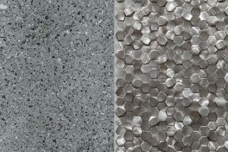 Close-up on granite tile and small, silver hexagonal tiles on wall, architectural detailの写真素材