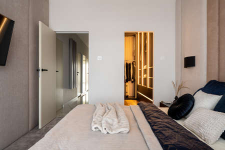 Spacious and elegant designed bedroom with big walk in closet, comfortable bed and nice decorated and tvの写真素材
