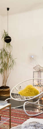 Vertical panorama of stylish white chair in unique designed room with many artistic and whimsical decorationsの写真素材