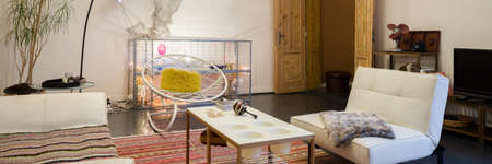 Panorama of eclectic and creative living room interior with vintage and stylish furniture, old wooden doors and artistic decorationsの写真素材