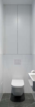 Vertical panorama of simple white toilet in small lavatory with gray floorの写真素材