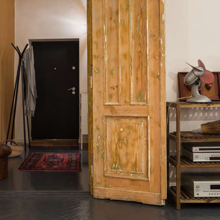 Amazing old wooden doors open to simple doorway in stylish tenement apartmentの写真素材