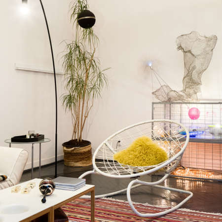 Stylish chair in quirky style room with many artistic and whimsical decorationsの写真素材