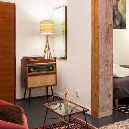 Close-up on vintage style radio with decorative lamp in eclectic roomの写真素材