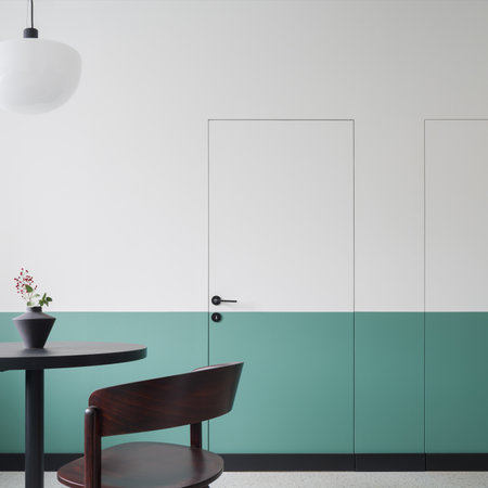 Modern design in dining room with half green and white doors and wall and with dark table and chair under new lampの写真素材