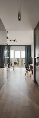 Vertical panorama of long apartment corridor with wooden floor and modern ceiling lightの写真素材