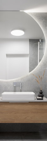 Vertical panorama of big, round mirror over washbasin in modern bathroomの写真素材