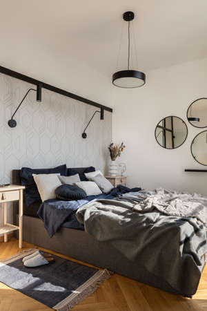 Big and nice decorated, cozy bed in bright and stylish bedroomの写真素材