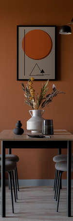 Vertical panorama of simple table in eclectic dining room with orange wall and artの写真素材