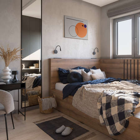 Stylish bedroom with bed in wooden frame, big mirror, decorations, desk and small windowの写真素材