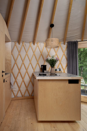Simple, small and functional wooden kitchen in yurt, holiday tentの写真素材