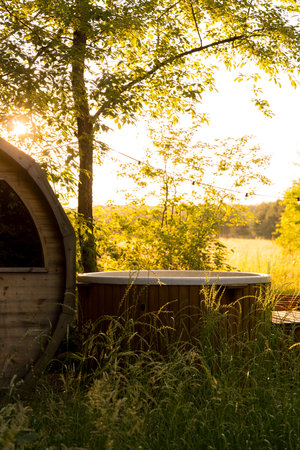 Simple relax area with hot tub in glamping campsite in forestの写真素材