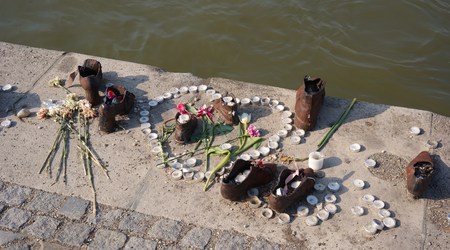 Shoes memorial with candles and flowers to the memory     in the World War IIのeditorial素材