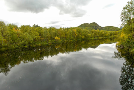 Autumn colorful nature of Finnmark region of Norway reflected in a river