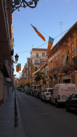 A street of Valencia decorated with Valencia flags during the Las Fallas Festival, Spainのeditorial素材