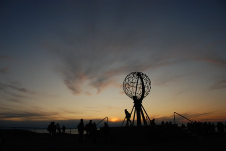 The sunset over a globe on North Cape, Nordkapp, Norwayの写真素材