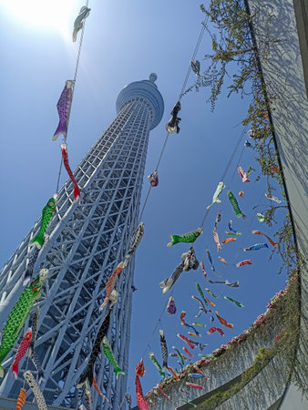 A bottom view of Tokyo Skytree, Japan, with flying koinobori during the Golden Weekの写真素材