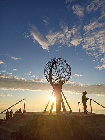 The midnight sun shining through the globe in Nordkapp (North Cape, the second northernmost point of Europe in Mageroya Island, Norwayの写真素材