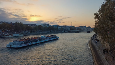 A boat sailing on the Seine River in Paris, France during the sunsetの写真素材