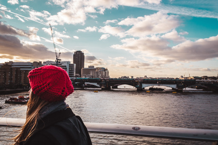 Photo of Girl crossing Millennium Bridge in Londonの写真素材