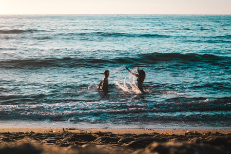 Photo of Couple Playing on the Beach at Sunset Cliffs, San Diegoの写真素材