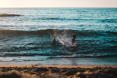 Photo of Couple Playing on the Beach at Sunset Cliffs, San Diegoの写真素材