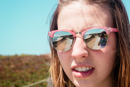 Photo of Pretty Girl With Sunglasses Near Beach in Californiaの写真素材