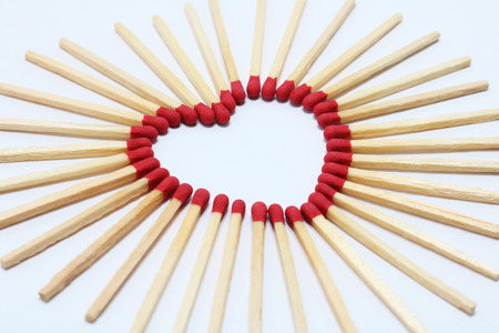 compose matches stick as a heart shape on white backgroundの写真素材