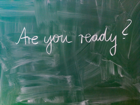 The slogan Are you ready handwritten with chalk on a green chalkboard.の写真素材
