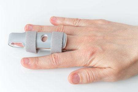 Grey plastic two-sided Finger Splint with two convenient hook-and-loop straps on an broken middle...