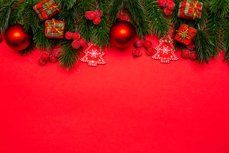Holiday Christmas background. Festive composition for the Christmas & New Year holiday season. Red decorations and pine branches with copy space.の写真素材