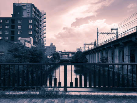 Along the way on the bridge across the river with building and construction in rural areas in moodyの素材