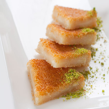 Close up shot of Turkish sweet, kunefe, with pistachios.